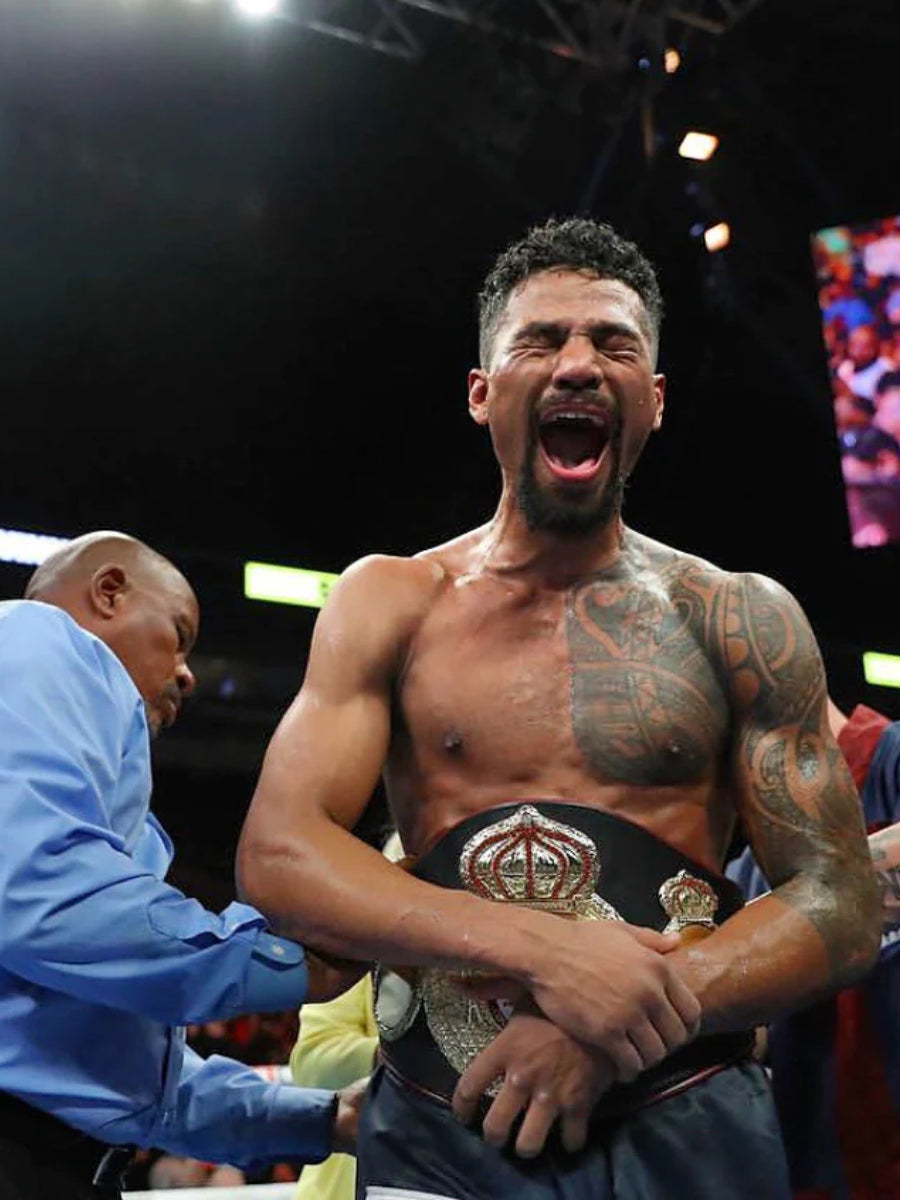boxer with belt being wrapped around waste by official